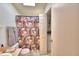 Clean bathroom with floral shower curtain and built-in shelving at 1742 Fox Hill Dr, Lakeland, FL 33810