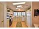 Galley style kitchen with light cabinets and wood flooring at 1742 Fox Hill Dr, Lakeland, FL 33810