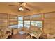 Enclosed porch with wicker furniture and ceiling fan at 1742 Fox Hill Dr, Lakeland, FL 33810