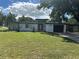 Mid-century modern home with white exterior, black accents, and a spacious lawn at 2128 Sycamore Dr, Winter Park, FL 32789