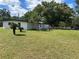 White mid-century modern home with a large backyard at 2128 Sycamore Dr, Winter Park, FL 32789