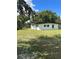 White mid-century modern home with a large backyard at 2128 Sycamore Dr, Winter Park, FL 32789