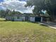 Mid-century modern home with white exterior, black accents, and a spacious lawn at 2128 Sycamore Dr, Winter Park, FL 32789