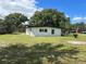 White mid-century modern home with a large backyard at 2128 Sycamore Dr, Winter Park, FL 32789
