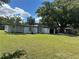 Mid-century modern home with white exterior, black accents, and a spacious lawn at 2128 Sycamore Dr, Winter Park, FL 32789