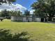 Mid-century modern home with white exterior, black accents, and a spacious lawn at 2128 Sycamore Dr, Winter Park, FL 32789