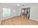 Bright living room with light laminate flooring and view into kitchen at 2235 Grand Cypress Dr # 561, Lakeland, FL 33810