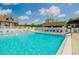 Community pool with lounge chairs at 2235 Grand Cypress Dr # 561, Lakeland, FL 33810