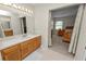 Bathroom with double vanity, view of bedroom, and shower at 3517 Highland Fairways Blvd, Lakeland, FL 33810