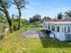 Backyard with concrete slab and partial home view at 1220 Woodland Ave, Lakeland, FL 33801