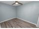 Simple bedroom with ceiling fan and wood-look floors at 1220 Woodland Ave, Lakeland, FL 33801