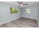 Spacious bedroom with two windows and wood-look floors at 1220 Woodland Ave, Lakeland, FL 33801