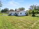 Large backyard with grassy area and home exterior view at 1220 Woodland Ave, Lakeland, FL 33801