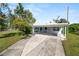 Light blue house with carport and driveway at 1220 Woodland Ave, Lakeland, FL 33801