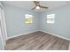 Bright bedroom with two windows and wood-look floors at 1220 Woodland Ave, Lakeland, FL 33801