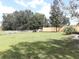 Spacious backyard with grassy area, wooden fence and trees at 1140 Durham Dr, Lakeland, FL 33809