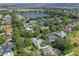 Aerial view of neighborhood with lake and houses at 109 Costa Loop, Auburndale, FL 33823