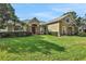 Two-story house with stone accents and landscaped yard at 109 Costa Loop, Auburndale, FL 33823