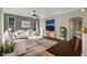 Virtually staged living room with modern furniture and hardwood floors at 109 Costa Loop, Auburndale, FL 33823