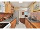 Open kitchen with granite countertops and wood cabinets, view to dining area at 2203 Starboard Rd, Winter Haven, FL 33881