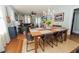 Bright dining room features a wood table with seating for six, hardwood floors and a view into the kitchen at 308 Allamanda Dr, Lakeland, FL 33803