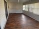 Sunroom featuring wood-look flooring and multiple windows at 4904 Goldenview Ln, Lakeland, FL 33811