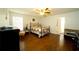 Spacious bedroom with dark wood floors and ceiling fan at 1015 Highland Crest Cir, Lake Wales, FL 33853