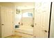 Bathroom with soaking tub and updated tile work at 1015 Highland Crest Cir, Lake Wales, FL 33853