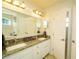 Elegant bathroom with granite countertops, double sinks, and a large mirror at 1015 Highland Crest Cir, Lake Wales, FL 33853
