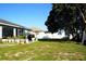 Large backyard with grassy area and mature plants at 1015 Highland Crest Cir, Lake Wales, FL 33853