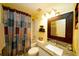 Bright bathroom with shower/tub combo and granite vanity at 1015 Highland Crest Cir, Lake Wales, FL 33853