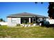 House back exterior with screened porch and potted plants at 1015 Highland Crest Cir, Lake Wales, FL 33853