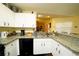 Updated kitchen boasts granite countertops and white cabinets at 1015 Highland Crest Cir, Lake Wales, FL 33853