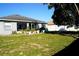 Large backyard with grassy area and mature plants at 1015 Highland Crest Cir, Lake Wales, FL 33853