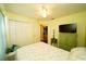 Bedroom with a queen bed, ceiling fan, and access to another room at 1015 Highland Crest Cir, Lake Wales, FL 33853