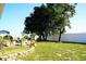 Spacious backyard with large trees and a patio area at 1015 Highland Crest Cir, Lake Wales, FL 33853