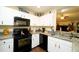 Modern kitchen featuring black appliances and granite countertops at 1015 Highland Crest Cir, Lake Wales, FL 33853