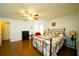 Bright bedroom featuring wood floors and ceiling fan at 1015 Highland Crest Cir, Lake Wales, FL 33853