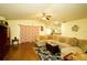 Living room featuring a sectional sofa and ceiling fan at 1015 Highland Crest Cir, Lake Wales, FL 33853