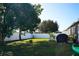 Large backyard with green grass, trees, and a grill at 1015 Highland Crest Cir, Lake Wales, FL 33853