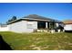 Large backyard with grassy area and mature plants at 1015 Highland Crest Cir, Lake Wales, FL 33853