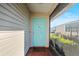 Light teal front door with screened porch entry at 4904 Goldenview Ln, Lakeland, FL 33811