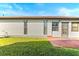 Side view of a single-story house with light-colored siding and a small patio at 4904 Goldenview Ln, Lakeland, FL 33811