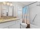 Updated bathroom with granite countertop, white cabinets, and a shower/tub combo at 4904 Goldenview Ln, Lakeland, FL 33811
