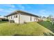 Side view of a single-story house showcasing a neat lawn and air conditioning unit at 4904 Goldenview Ln, Lakeland, FL 33811
