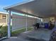Covered carport with storage and a fenced backyard at 1744 Quail Hill Dr, Lakeland, FL 33810