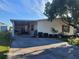 Mobile home with carport and landscaped yard at 1744 Quail Hill Dr, Lakeland, FL 33810