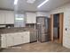 Updated kitchen with white cabinets, stainless steel appliances, and tile flooring at 1744 Quail Hill Dr, Lakeland, FL 33810