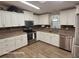 Bright kitchen with white cabinets, stainless steel appliances, and tile floors at 1744 Quail Hill Dr, Lakeland, FL 33810