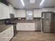 Galley kitchen with white cabinets and stainless steel appliances at 1744 Quail Hill Dr, Lakeland, FL 33810